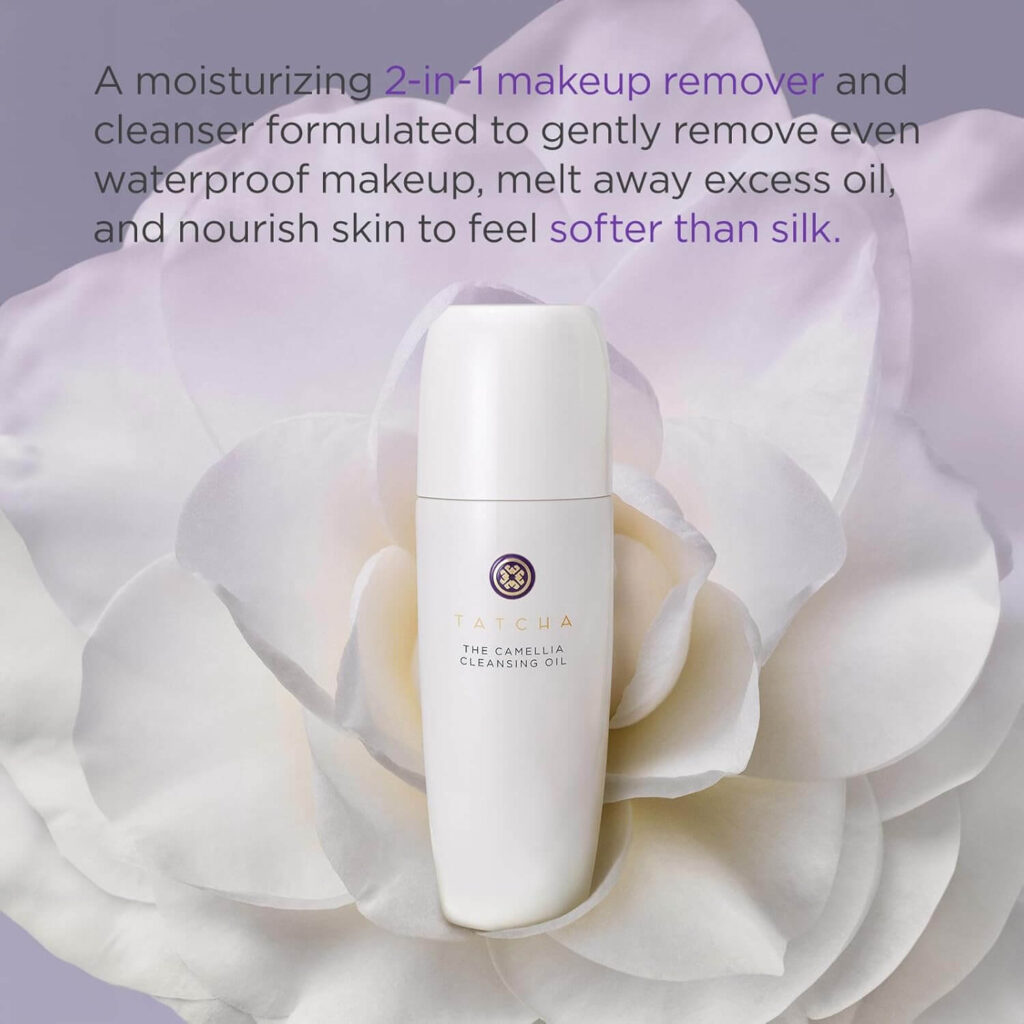 Tatcha Camellia Cleansing Oil Face Wash featured on a white flower background, showcasing its 2-in-1 makeup remover and cleanser formula that removes waterproof makeup and leaves skin softer than silk.